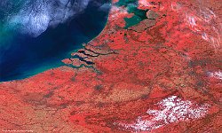 Rhine and Schedlt Delta  PROBA-V was launched in May 2013 to ensure continuation of the 15-year SPOT-VEGETATION global vegetation time series, bridging the gap to Sentinel-3 for land applications. After almost 5 years of successful and high-quality operations, PROBA-V is consolidating its role as key data provider to the Copernicus Global Land Service and as valuable complement to the Sentinel-2 and Sentinel-3 sensors. From 29 – 31 May, the PROBA-V Symposium gathers scientists, students, end-users, and other stakeholders to present and discuss the latest scientific and operational results and applications. To highlight this event, we present a 100 m image of Belgium and parts of its neighbouring countries. Ostende is located at the coast near the Zeebrugge harbour in the middle-left part of the image. Further, several Belgian cities, such as Brussels, Antwerp, Liège, and Ghent can be located by the grey areas. And in the lower-right part you can recognize the snow-covered Belgian Ardennes.   Date: 25/02/2018   Resolution: 100m : rhine, scheldt, delta, belgium, symposium, ostende, harbour