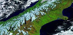 New Zealand  The PROBA-V image at 300 m resolution, acquired mid July 2016, takes a closer look at the South island, also called Te Waipounamu in Māori, the largest but least populated island of New Zealand.  On the east coast of the island, we see the circular Banks Peninsula, formed by the remnants of two large shield volcanoes and nowadays characterized by two deep harbours and many smaller bays and coves. The South Island's largest city, Christchurch, is immediately north of the peninsula, along the coast of Pegasus Bay. But the real eye-catcher in the image are the beautiful mountains of the Southern Alps, with 18 peaks over 3000 meter high - the highest being Mount Cook - several national parks, glaciers, fjords and ski resorts. The western coast of the island, facing the Tasman Sea, has an extremely wet climate, whereas the eastern part is semi-arid.   Date: 15/07/2016   Resolution: 300m : new zealand, islands, maori, peninsula, pegasus, bay, alps