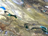 Qaidam Basin, China  The 100 m image of 26 April 2014 shows us Qaidam Basin, an hyperarid basin with an area of approximately 120,000 km², one fourth of which is covered by saline lakes and playas. By one count, there are 27 such lakes in the basin. In this PROBA-V image we see the West and East Taiji Nai'r Laken at the left side, in the middle Senie Lake and at the right Dabuxun Lake. After zooming in, you can see the infrastructures built for the reclamation of salt and other minerals.   Date: 26/04/2014   Resolution: 100m : qaidam, basin, china, lake, salt