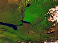 Chardara reservoir & Aydar Lake  The 100 m false-colour image of 6 March 2016 shows us (at left) Lake Aydarkul, part of the man-made Aydar-Arnasay system of lakes, which covers an area of 4,000 square kilometres. This system includes 3 brackish water lakes (Aydar Kul, Arnasay and Tuzkan) located in the saline depressions of the south-eastern Kyzyl Kum (now in Uzbekistan and Kazakhstan). In the early sixties the Syr Darya was dammed up. Simultaneously the Chardarya irrigation dam was constructed (light spot in the middle). Floodgates were provided in the dam for flood control, and when in 1969 a raging flood occurred, these were opened as the dam's capacity was inadequate to cope with the flow. Between February 1969 and February 1970 almost 60% of the Syr Darya's average annual water flow (21 km³) was drained from the Chardarya Reservoir (lake in middle of the image) into the Arnasay lowland. In such a way new lakes were unintentionally created. Since 1969 the Aydar Lake has regularly received the waters of the Syr Darya River when they overflow the capacity of the Chardarya Reservoir. This has gradually filled up the natural cavity of Arnasay lowland to create the second largest lake in the region (after the remains of the Aral Sea).   Date: 06/03/2016   Resolution: 100m : chardara, reservoir, aydar, lake, water, aral, sea