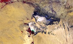Chott Melghir, Algeria  The 100 m false-colour PROBA-V image of 12 September 2017 shows us a mix of wadi, agriculture patterns, alluvial fans,  around Chott Melghir (upper center) and Chott Felrhir (lower center), 2 endorheic salt lakes in northeastern Algeria. It lies almost entirely below the sea level and contains the lowest point in Algeria, −40 meters. The shallow waters of the lake contain scarce vegetation composed of 72 species of plants which have adapted to salty water, such as Parish's glasswort, sea lavender, rushes, glasswort, etc. Some species are unique for Algeria and 14 are endemic.   Date: 12/09/2017   Resolution: 100m : chott, melghir, algeria, water, salt, agriculture