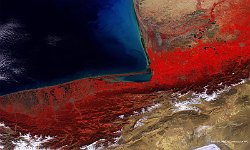 Caspian Sea, Iran-Turkmenistan  PROBA-V observations are increasingly used for water quality applications, such as information on chlorophyll concentration and water-suspended materials. The 100 m false-colour image of 8 March 2016 shows a potential application, with high Atrak river sediment concentrations that can be recognised by light-blue taints along the south-eastern Caspian coast. Further, the lower image part shows snow-covered peaks from the Alborz mountain range, while in the lower-right corner the Haj Aligholi Salt Lake is partly visible in white.   Date: 08/03/2016   Resolution: 100m : caspian, sea, turkmenistan, iran, coast, water